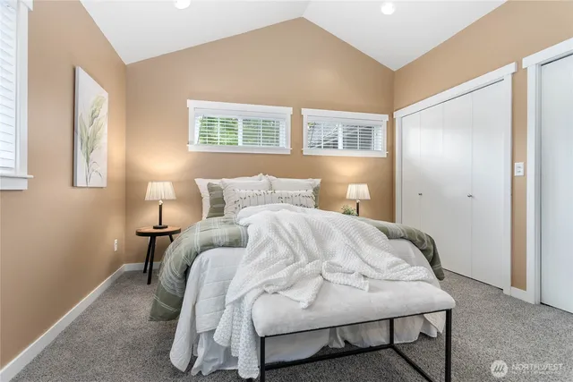 a bedroom with a bed and a window