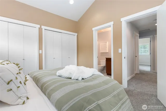 a bedroom with a large bed and walk in closet