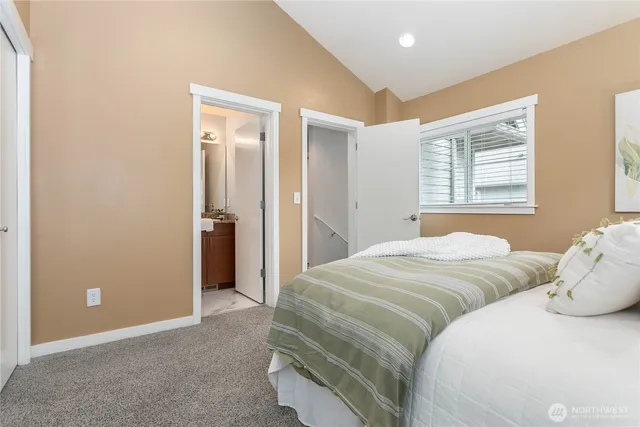 a bedroom with a bed and a painting