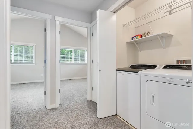 a view of hallway with washer and dryer