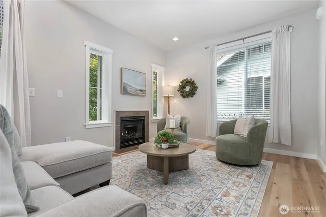 a living room with furniture a window and a fireplace