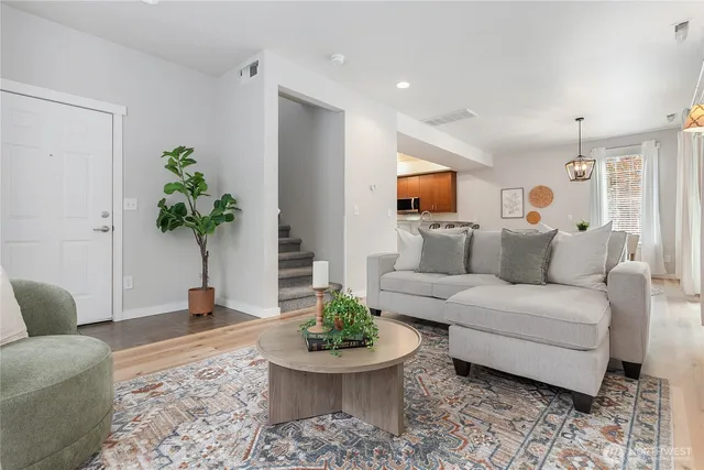 a living room with furniture and a potted plant