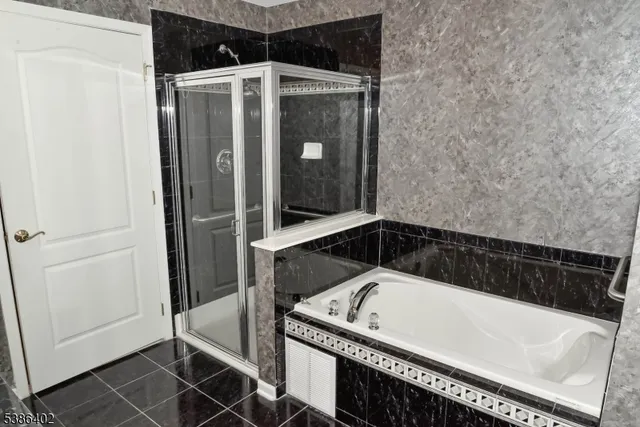 a bathroom with a tub and shower