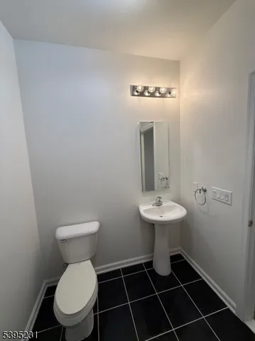 a bathroom with a sink toilet and a mirror