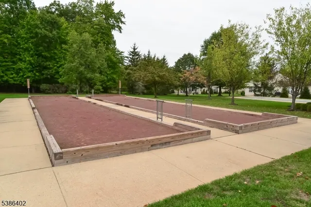 a front view of a house with a yard and fountain