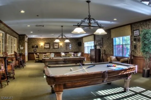 a view of a dining room with furniture and chandelier
