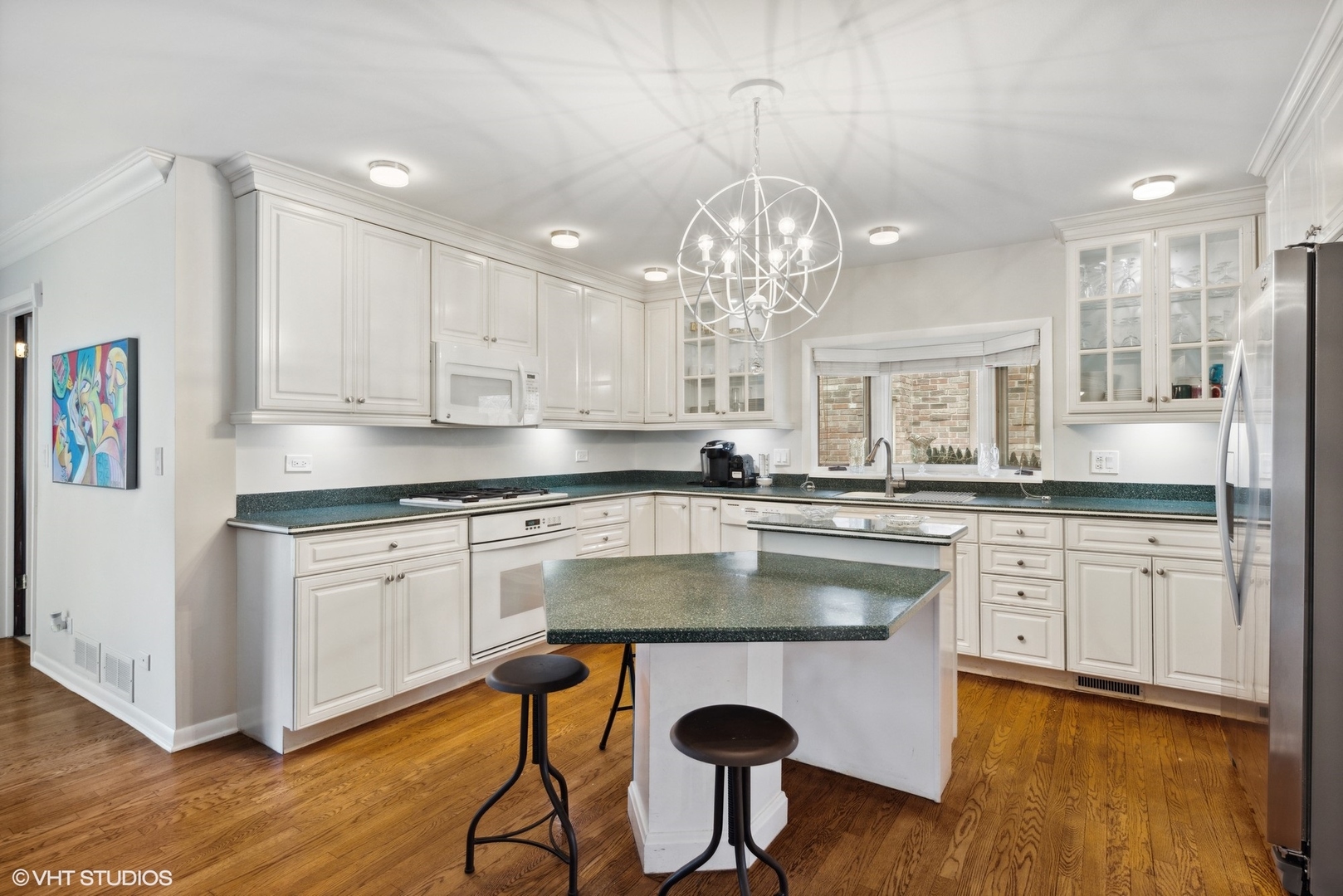 25 Princeton Road Hinsdale, IL 60521 - Photo 15 of 39 a kitchen with stainless steel appliances granite countertop a stove a sink dishwasher a dining table and chairs with wooden floor