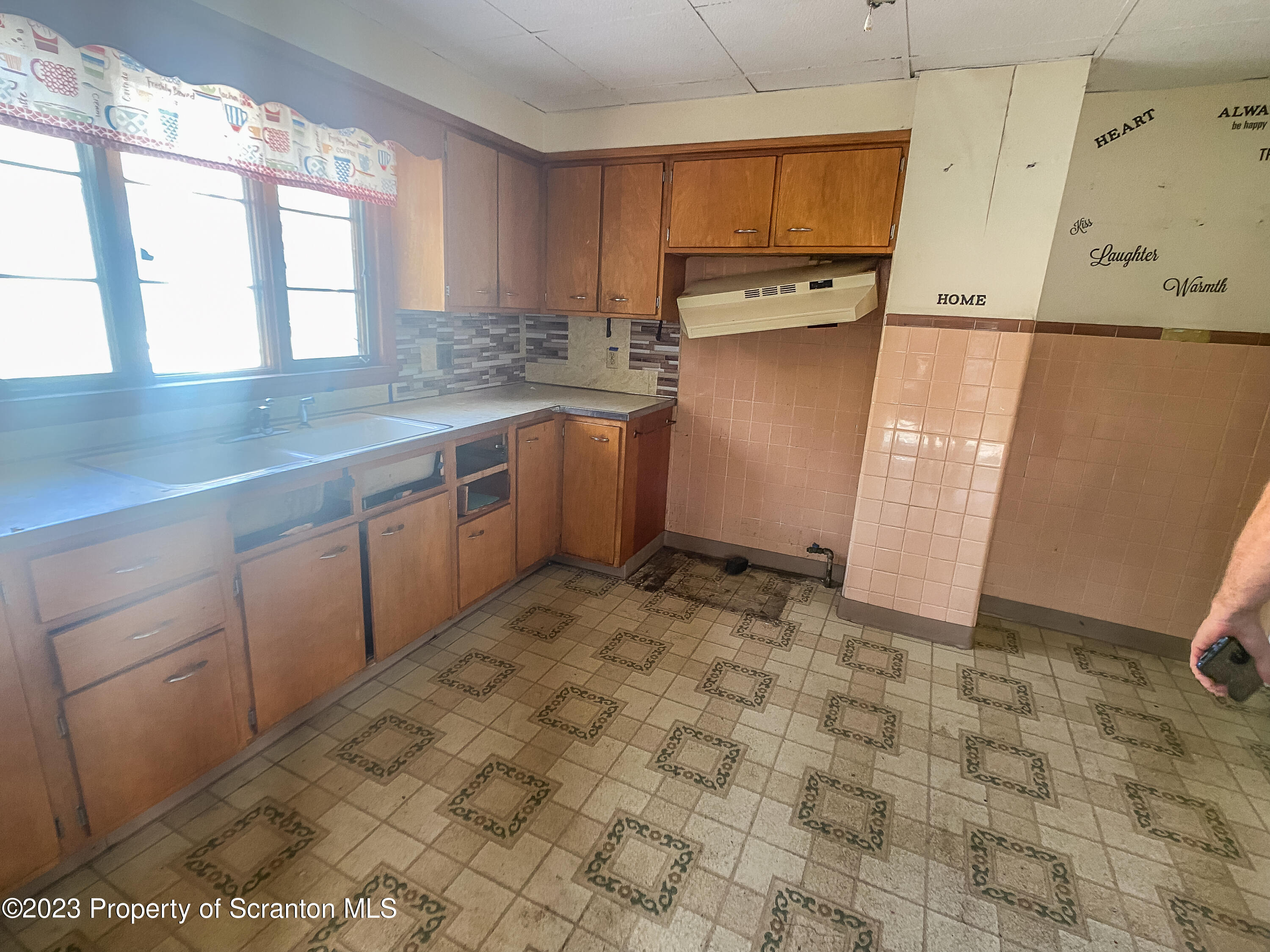 509 North Main Avenue Scranton, PA 18504 - Photo 11 of 16 a kitchen with a sink window and cabinets