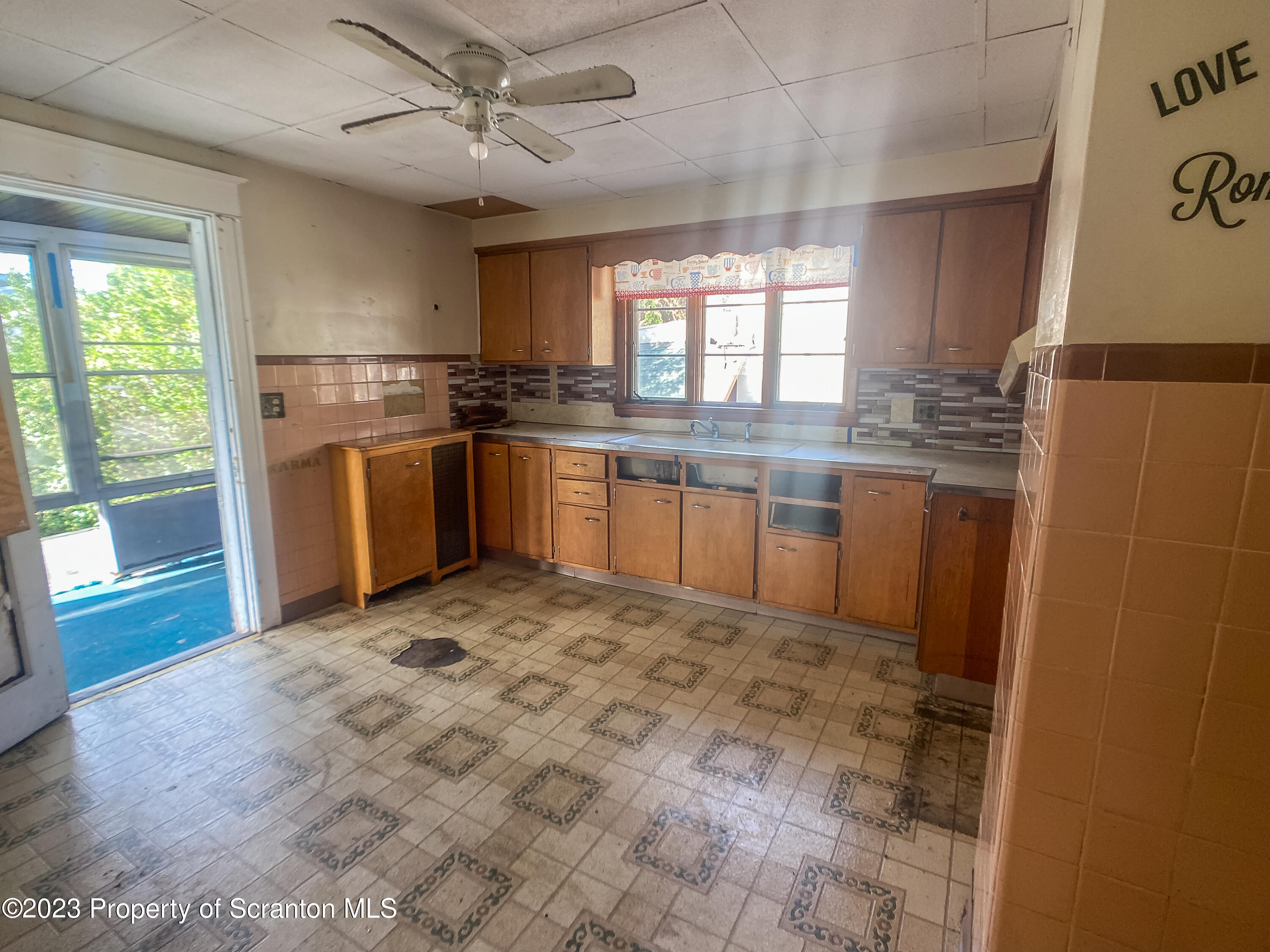 509 North Main Avenue Scranton, PA 18504 - Photo 12 of 16 a kitchen with stainless steel appliances granite countertop a refrigerator a sink a stove a microwave oven with a dining table and chairs