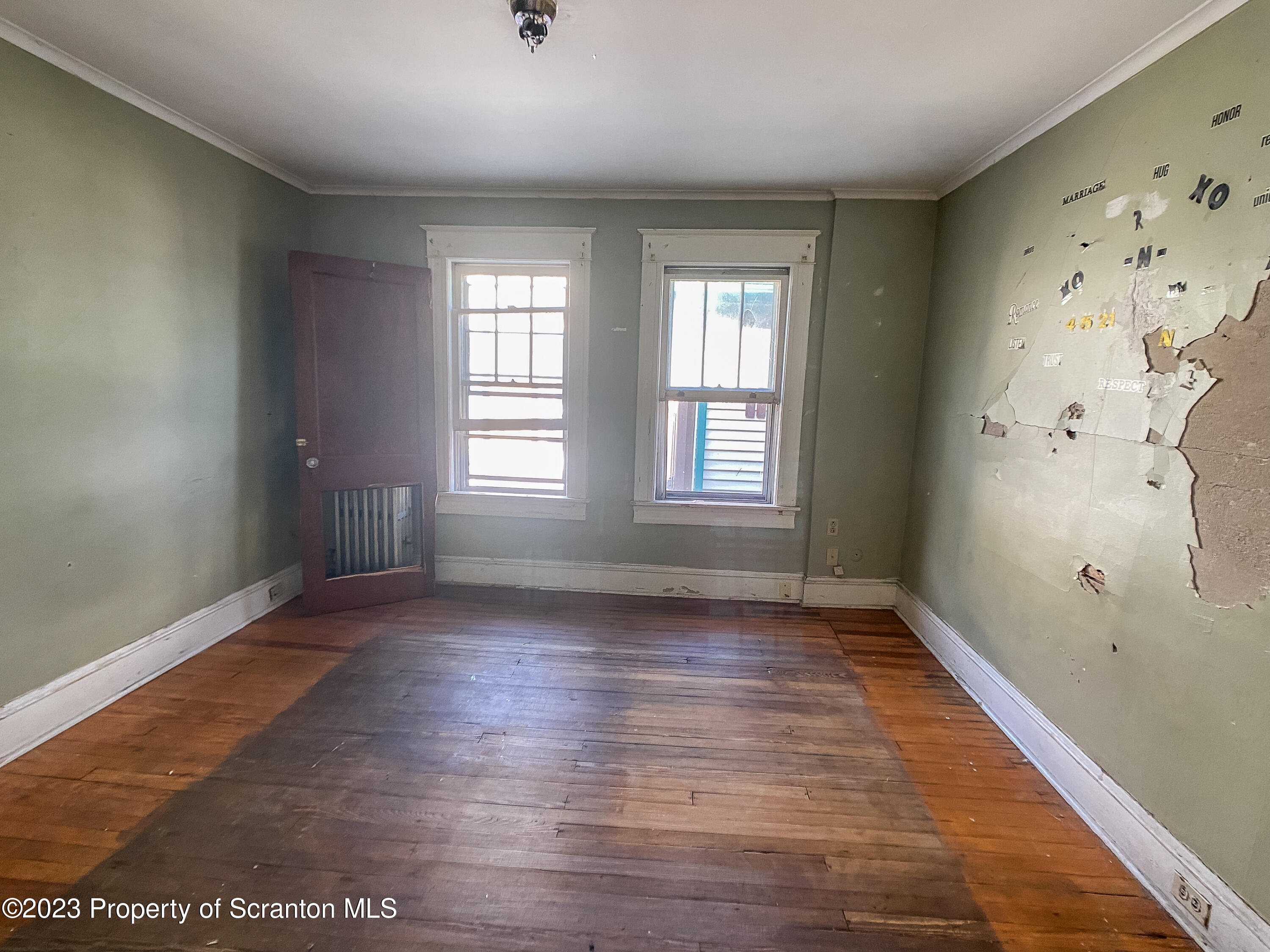 509 North Main Avenue Scranton, PA 18504 - Photo 13 of 16 a view of an empty room with wooden floor and a window