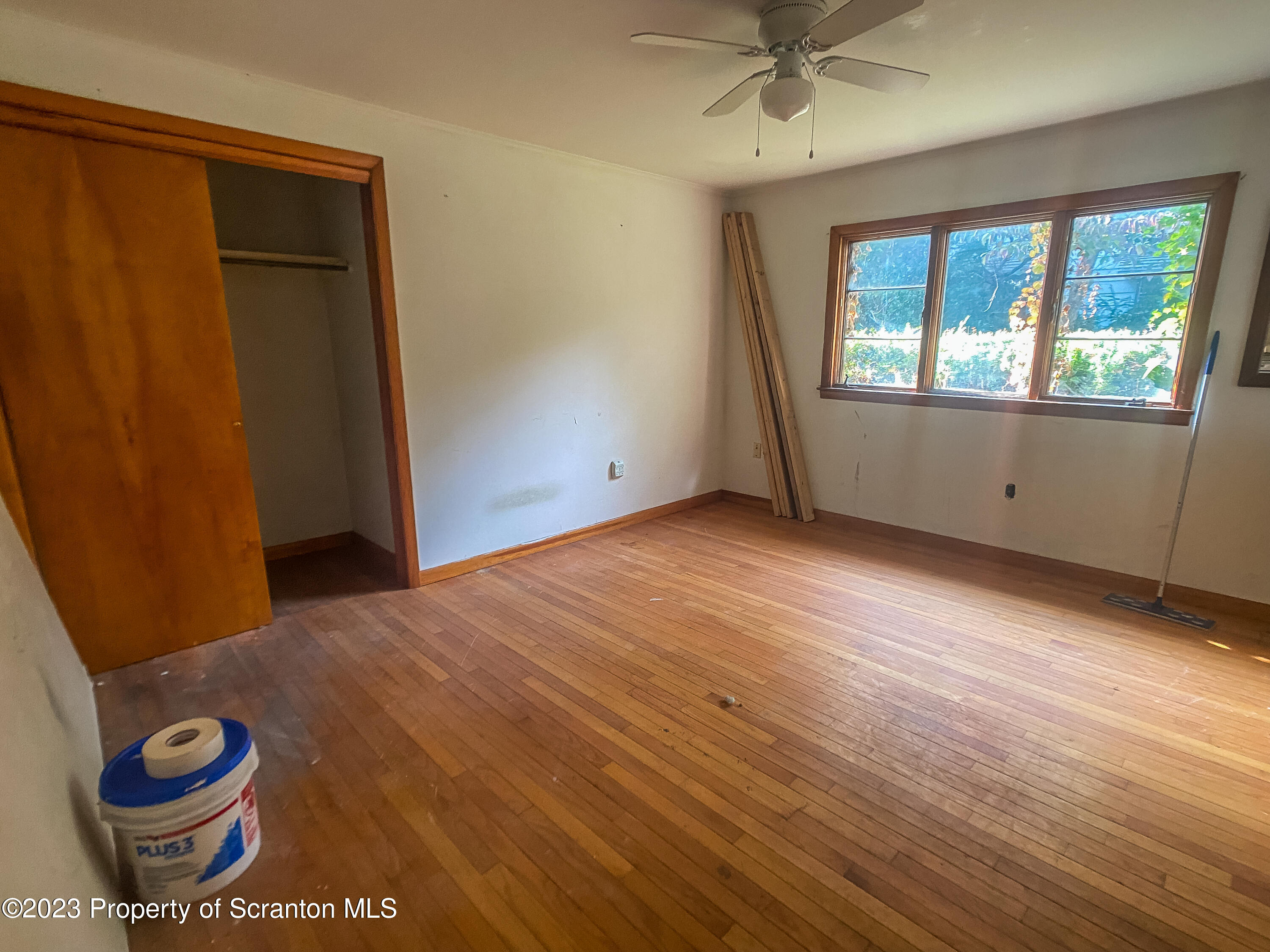 509 North Main Avenue Scranton, PA 18504 - Photo 6 of 16 an empty room with wooden floor and windows
