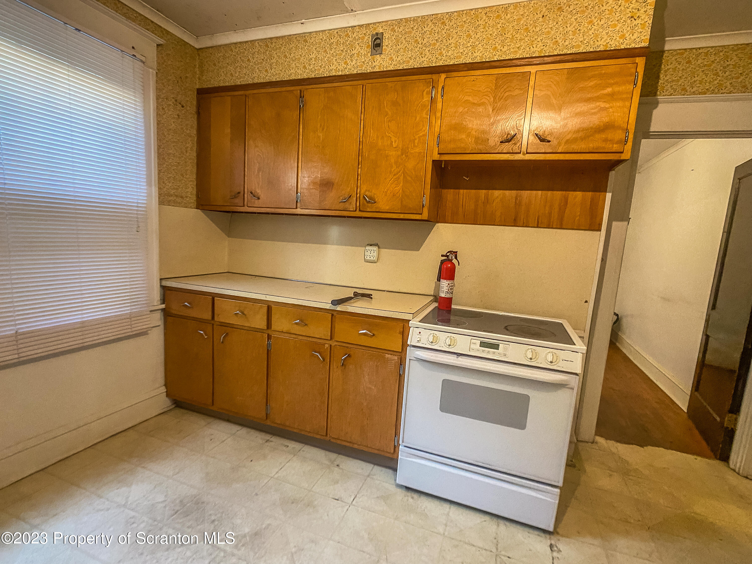 509 North Main Avenue Scranton, PA 18504 - Photo 7 of 16 a kitchen with a stove top oven sink and cabinets