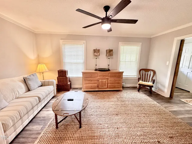 a kitchen with a dining table chairs and refrigerator