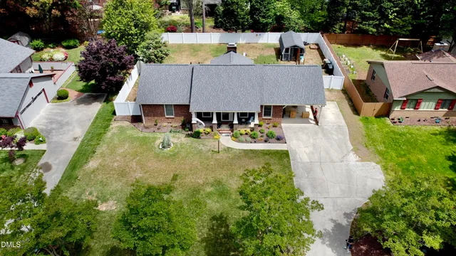 an aerial view of a house with swimming pool and big yard