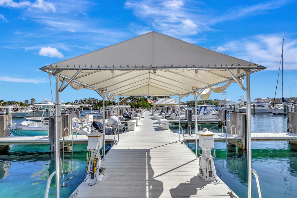 2755 Northeast 28th Avenue, Unit A3 Lighthouse Point, FL 33064 - Photo 25 of 27 a view of a patio with a table and chairs under an umbrella