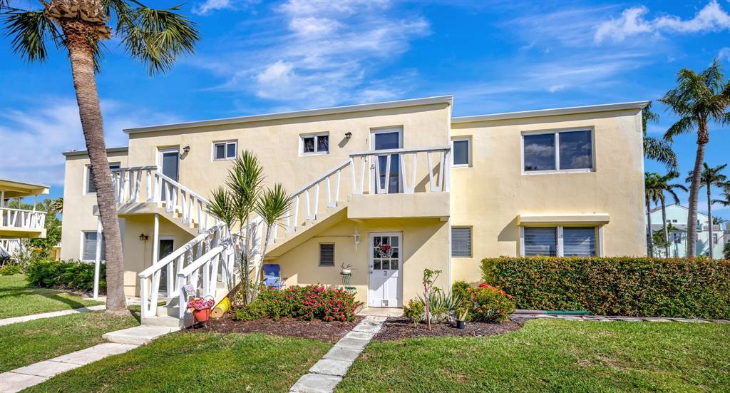 2755 Northeast 28th Avenue, Unit A3 Lighthouse Point, FL 33064 - Photo 3 of 27 front view of a house with a yard