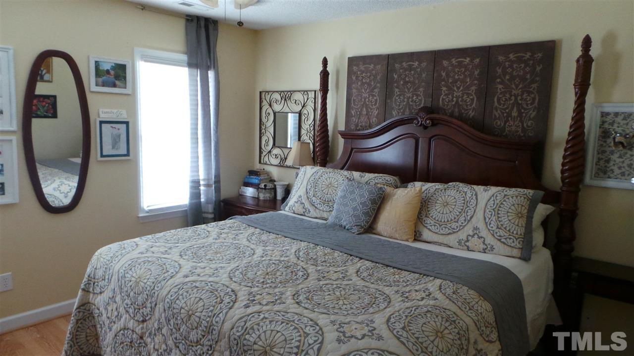 4400 Willow Lake Road Raleigh, NC 27616 - Photo 14 of 25 a bedroom with a bed a mirror with the dresser and a window