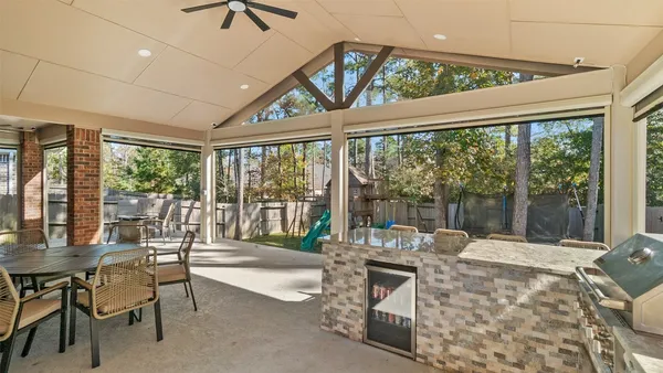 a living room with furniture and a floor to ceiling window