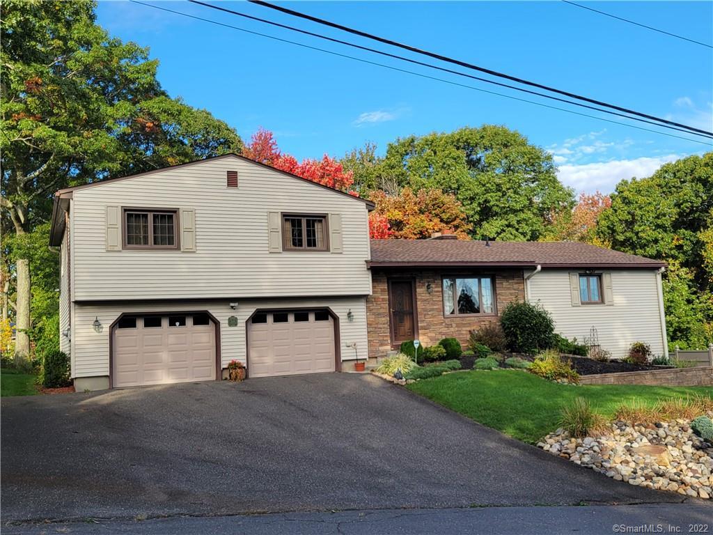 226 Juniper Ridge Drive Waterbury, CT 06708 - Photo 1 of 1 a front view of a house with a yard and garage