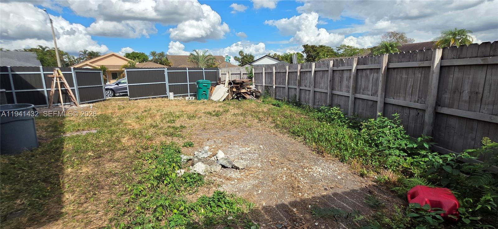 15238 Southwest 58th Terrace Miami, FL 33193 - Photo 13 of 46 a view of a garden with a wooden fence