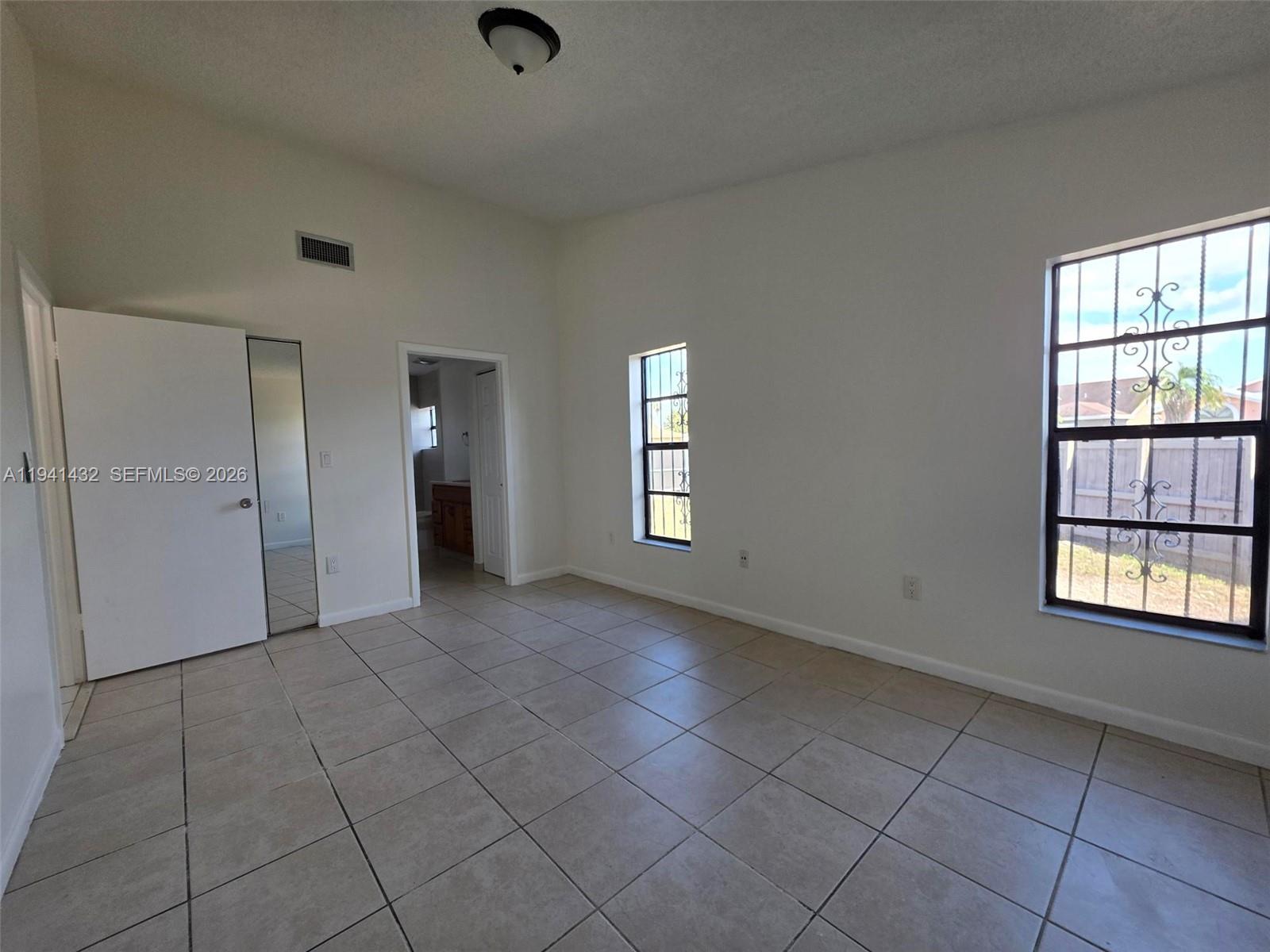 15238 Southwest 58th Terrace Miami, FL 33193 - Photo 14 of 38 an empty room with windows and closet
