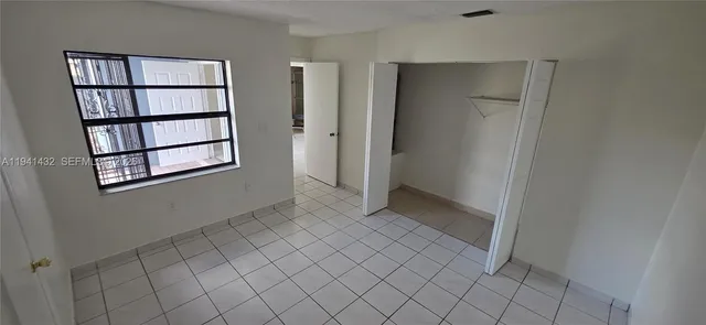 a kitchen with stainless steel appliances granite countertop a stove a microwave and a refrigerator