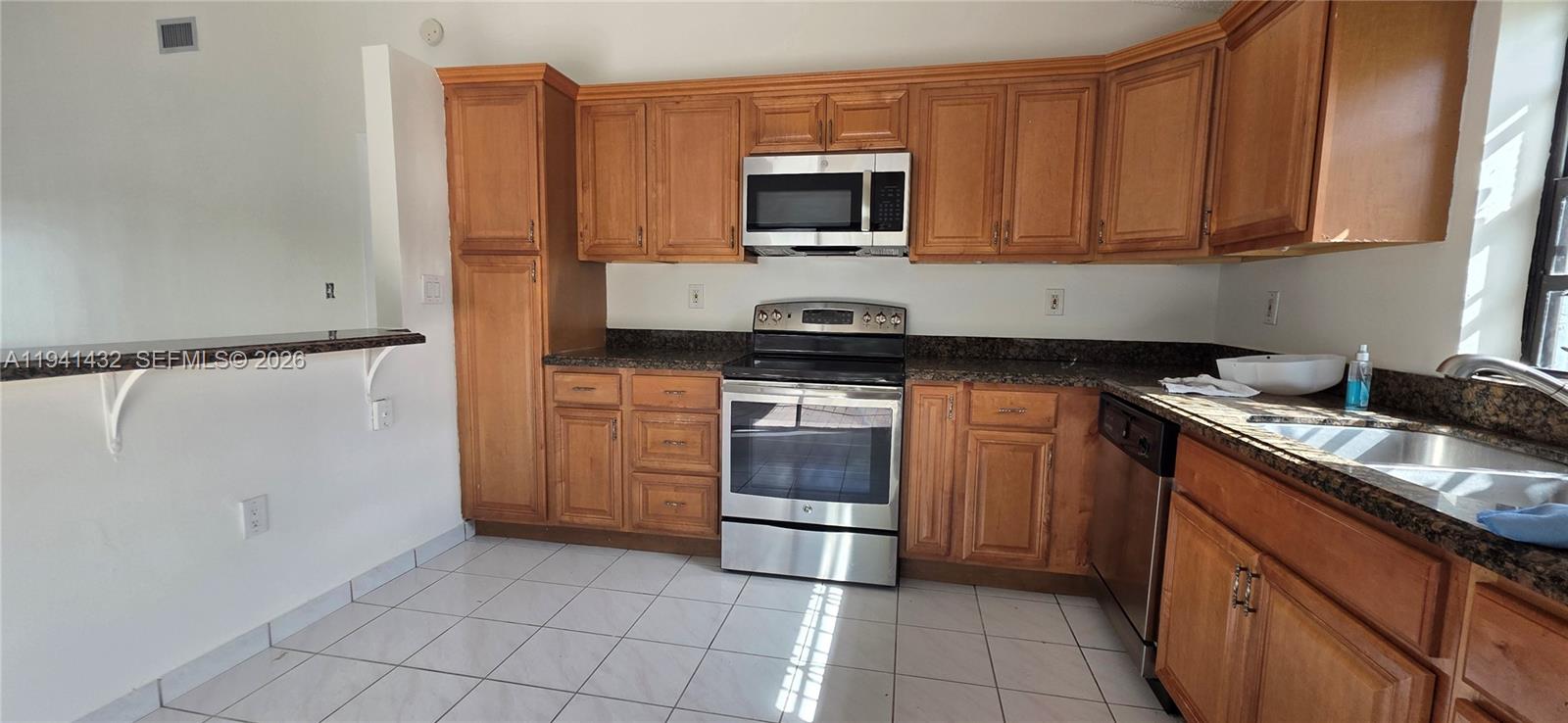 15238 Southwest 58th Terrace Miami, FL 33193 - Photo 20 of 46 a kitchen with a sink and a stove top oven