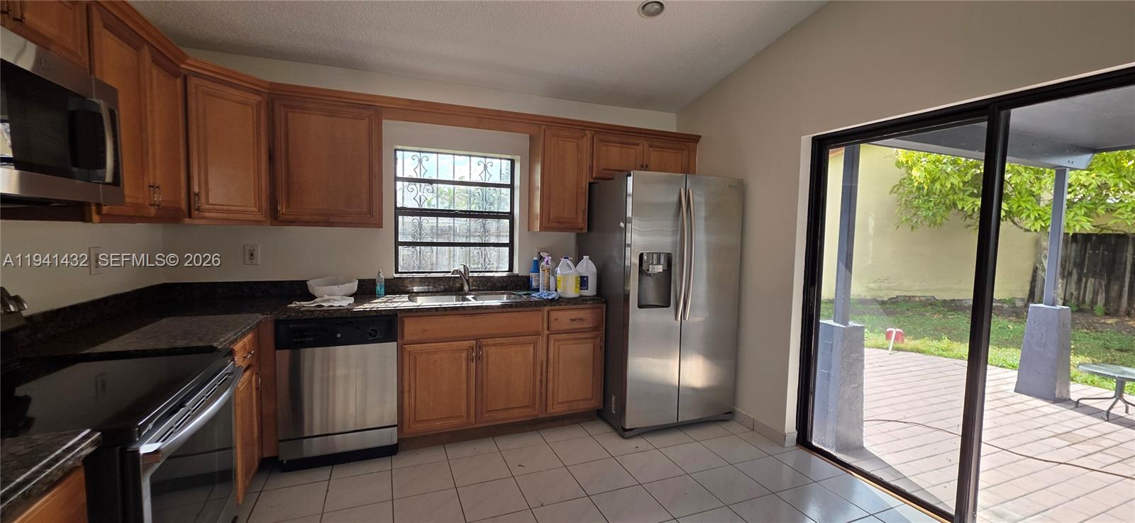 15238 Southwest 58th Terrace Miami, FL 33193 - Photo 21 of 46 a kitchen with stainless steel appliances granite countertop a refrigerator a sink and a stove