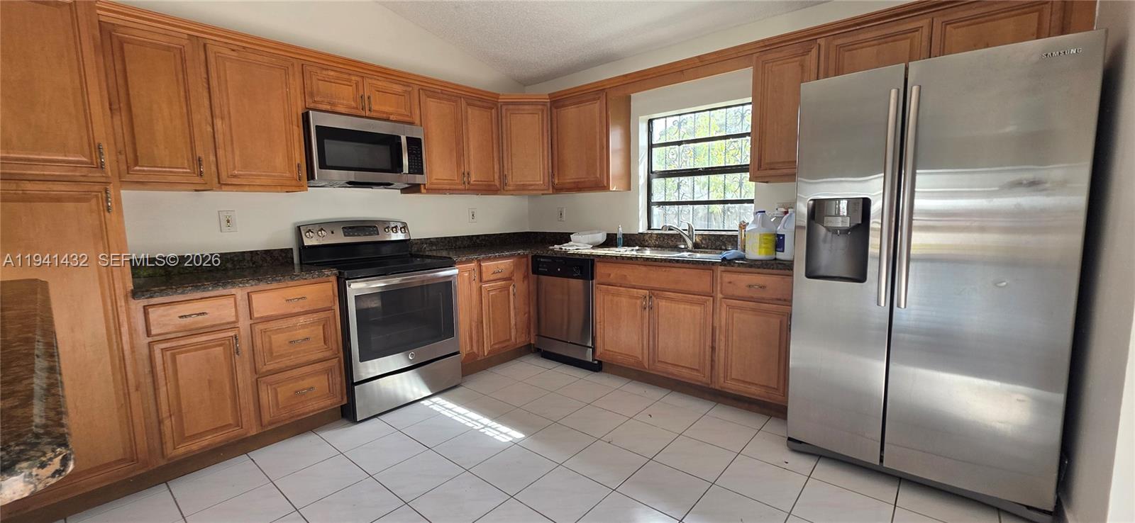 15238 Southwest 58th Terrace Miami, FL 33193 - Photo 23 of 46 a kitchen with a refrigerator stove top oven and sink