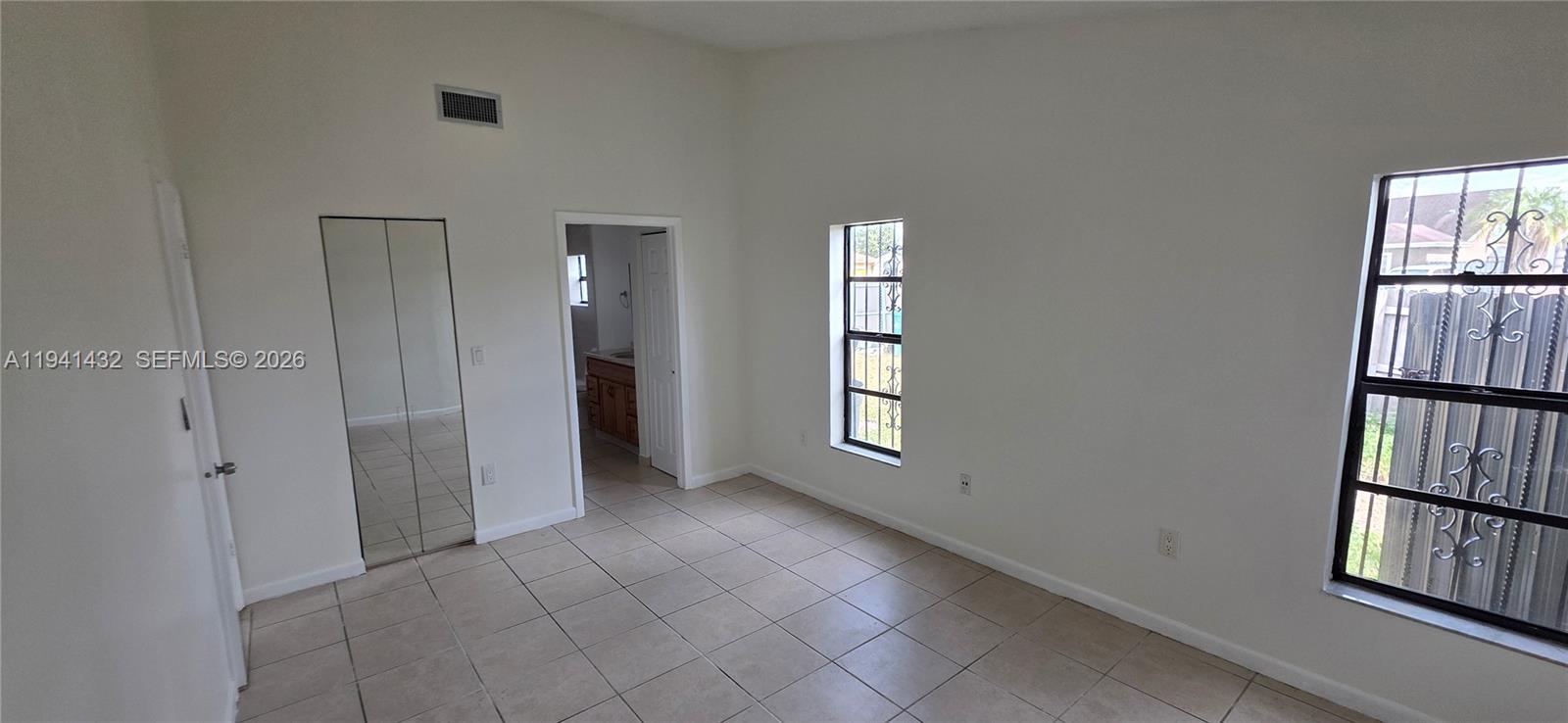 15238 Southwest 58th Terrace Miami, FL 33193 - Photo 27 of 46 wooden floor and windows in an empty room
