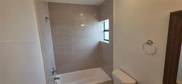 a bathroom with a glass shower door and a sink