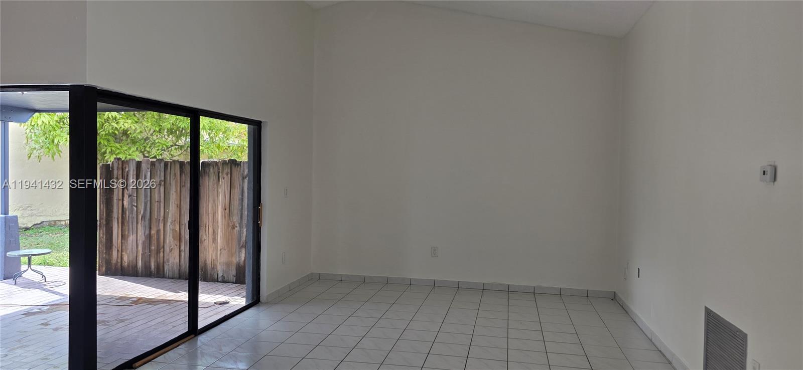 15238 Southwest 58th Terrace Miami, FL 33193 - Photo 44 of 46 an empty room with sliding glass door