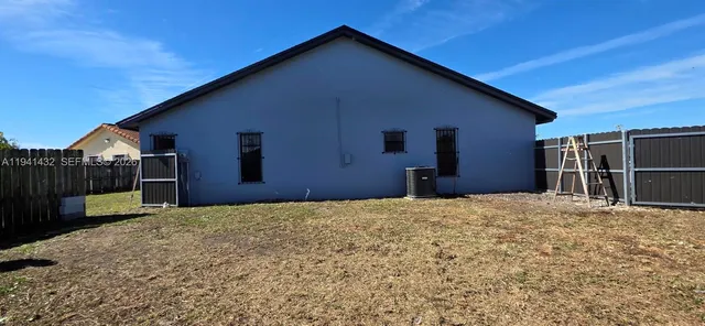 a view of a garden with a wooden fence
