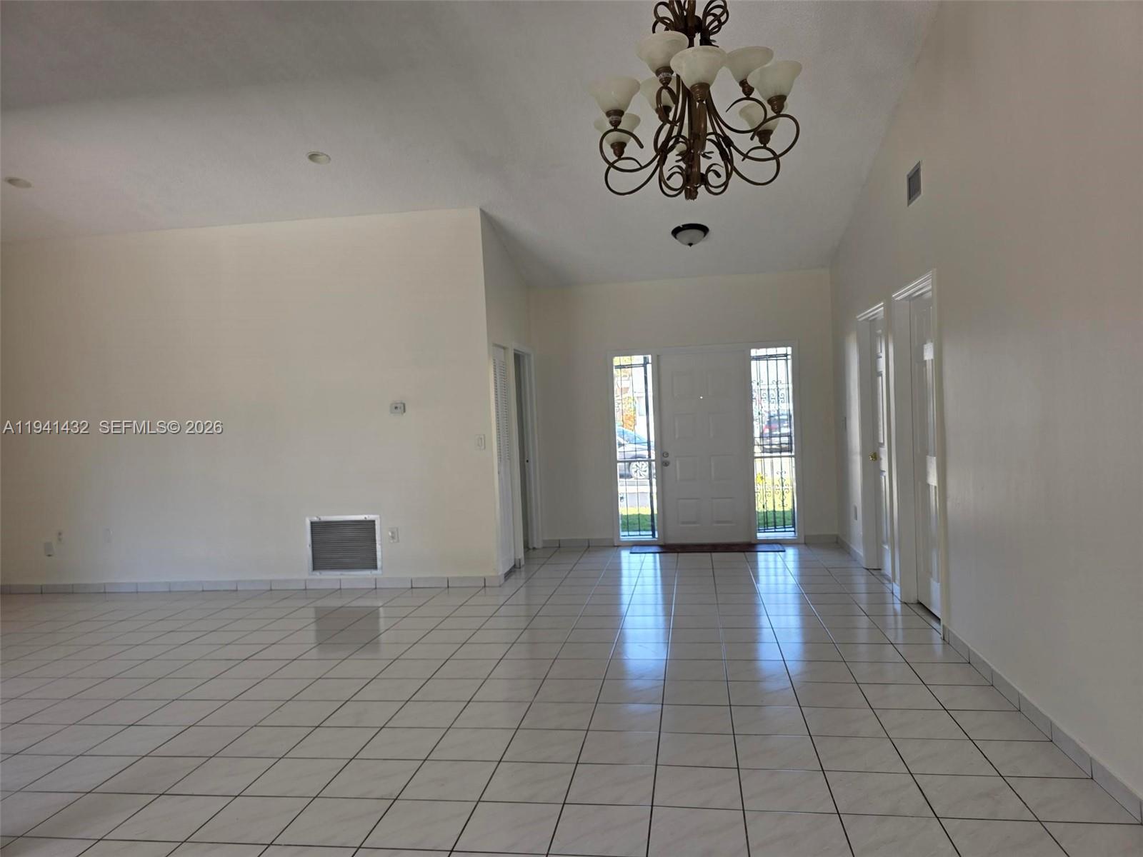 15238 Southwest 58th Terrace Miami, FL 33193 - Photo 9 of 38 a view of a hallway with a chandelier