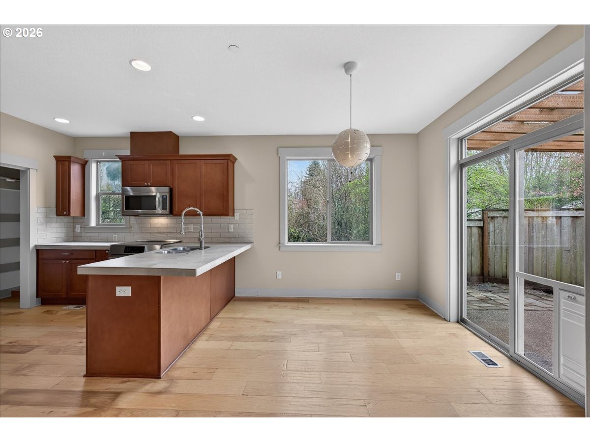 561 North Declaration Drive Carlton, OR 97111 - Photo 13 of 44 a large kitchen with kitchen island a large counter top space a sink stainless steel appliances and cabinets