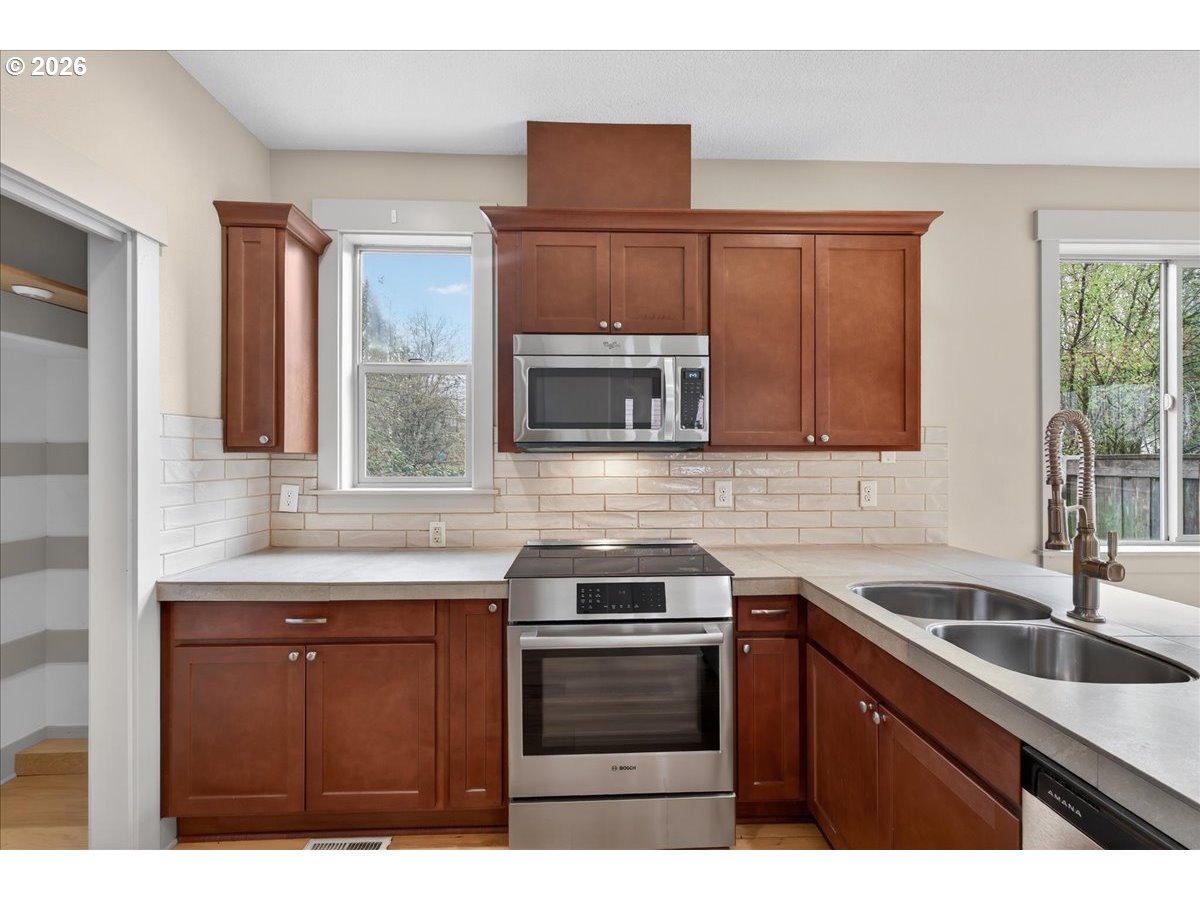561 North Declaration Drive Carlton, OR 97111 - Photo 7 of 44 a kitchen with granite countertop a sink stainless steel appliances and cabinets