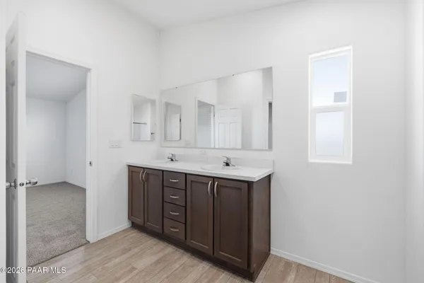 a bathroom with a double vanity sink and mirror