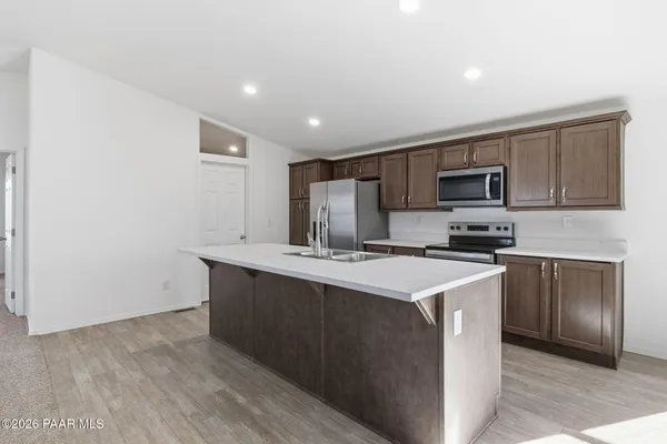 a kitchen with stainless steel appliances a sink stove and microwave