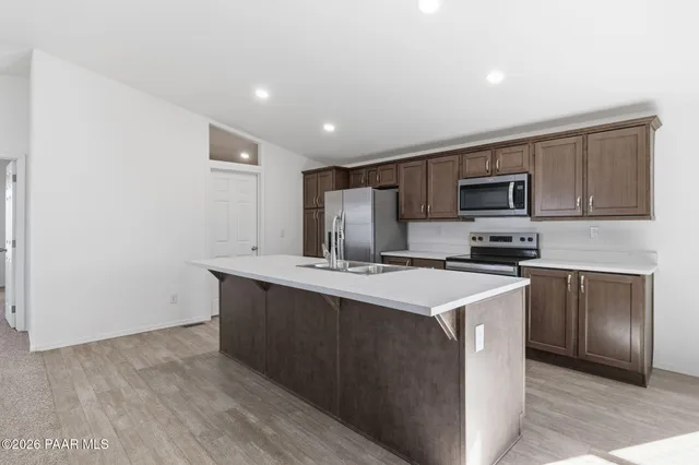 a kitchen with stainless steel appliances a sink stove and microwave