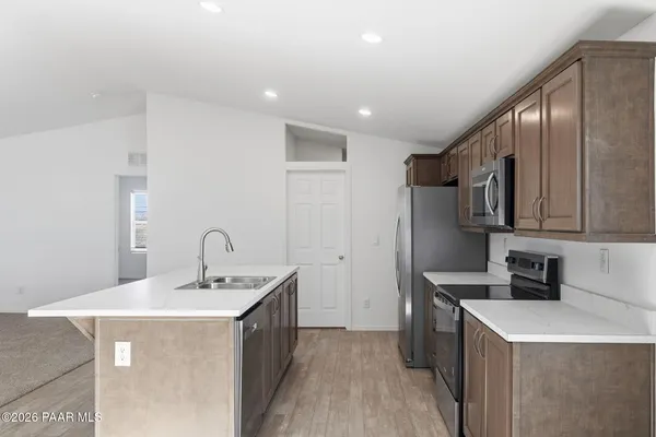 a kitchen with a sink a stove and cabinets