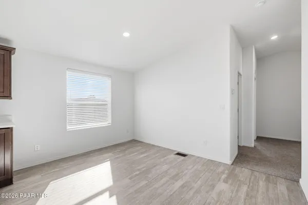 a view of an empty room and a window