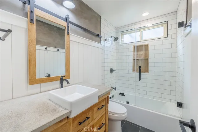 a bathroom with a sink toilet tub and shower