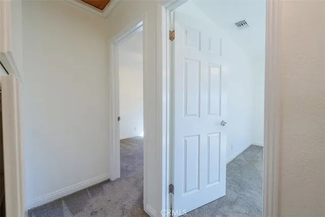 a view of a hallway with an entryway door