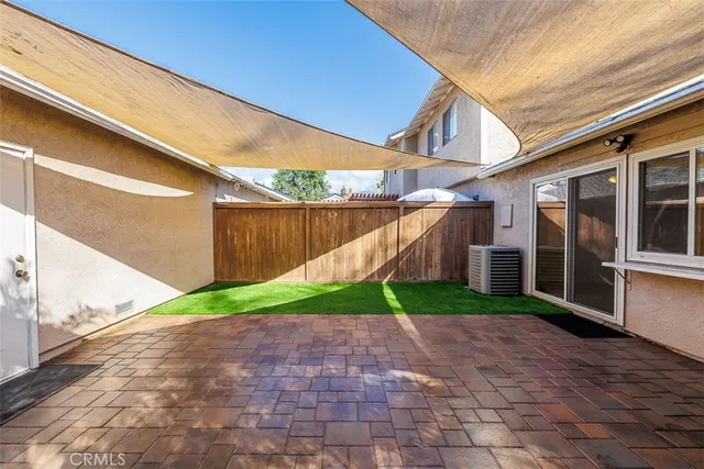 a yellow and red umbrella sitting in front of a building