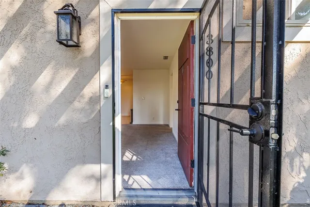a view of a hallway with wooden floor and entryway