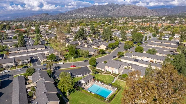 an aerial view of residential houses with outdoor space