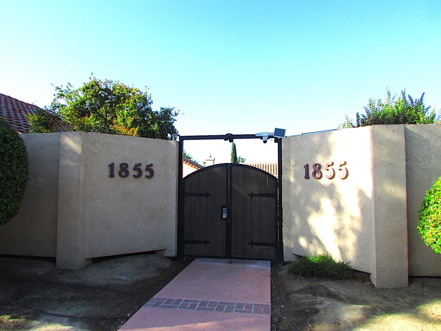a view of balcony with wooden floor and a garden