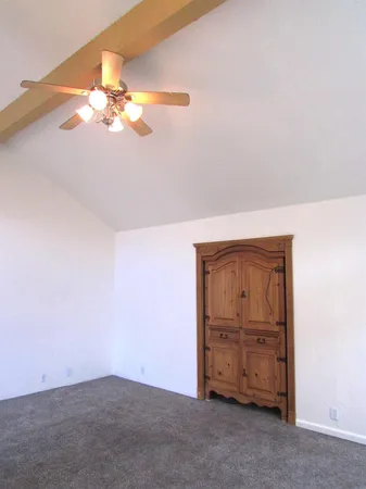 a view of empty room with window and chandelier