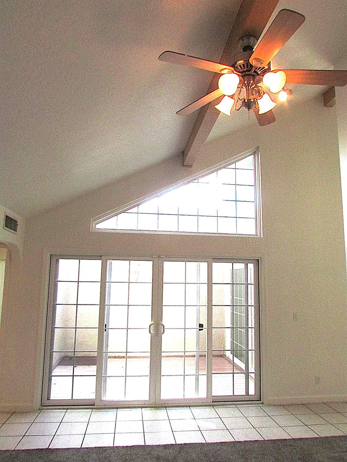 1855 Scenic Drive, Unit F Modesto, CA 95355 - Photo 14 of 52 a view of empty room with window and chandelier