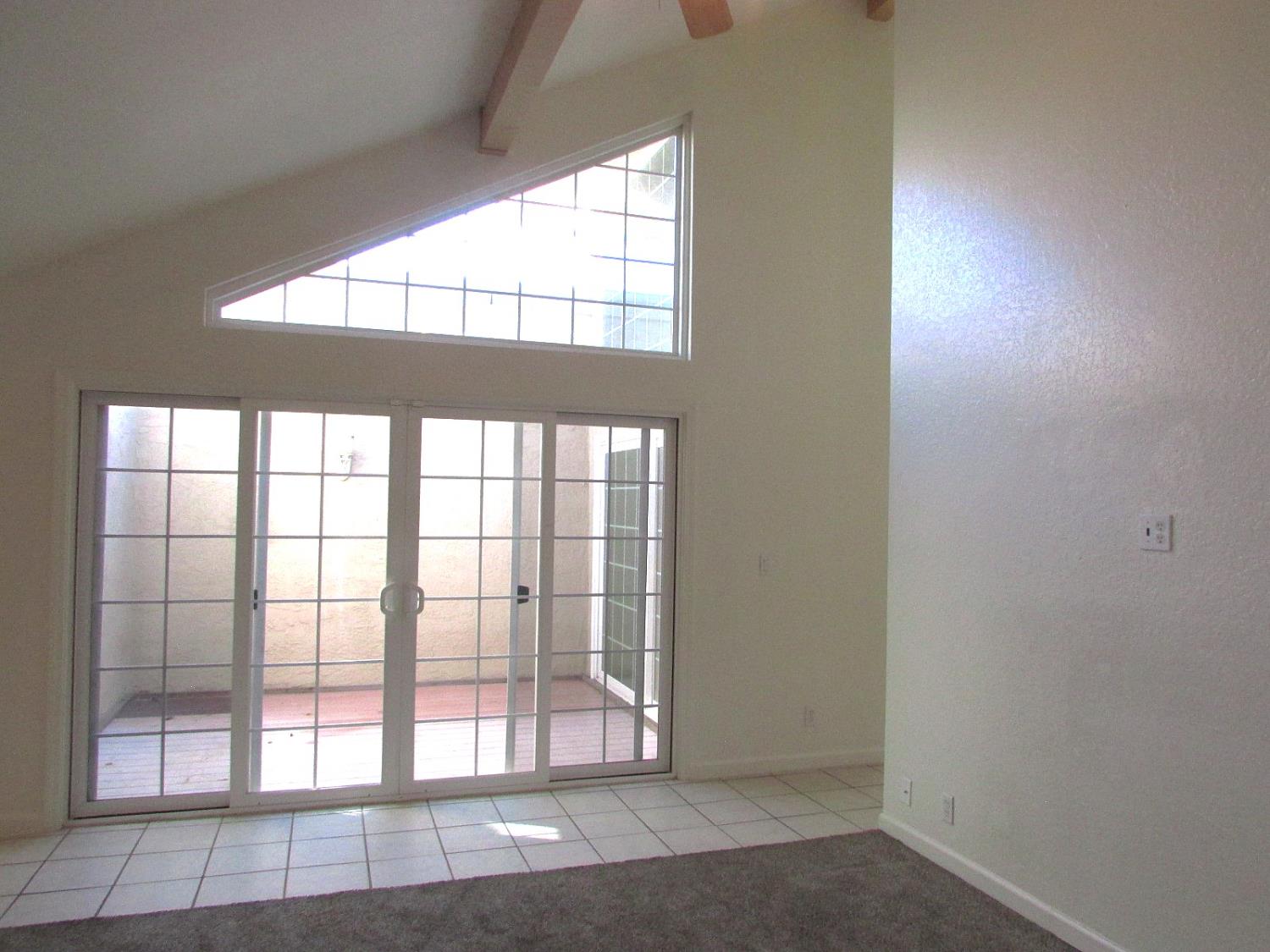 1855 Scenic Drive, Unit F Modesto, CA 95355 - Photo 15 of 52 an empty room with large windows